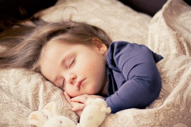 good sleep shown by a baby on bed