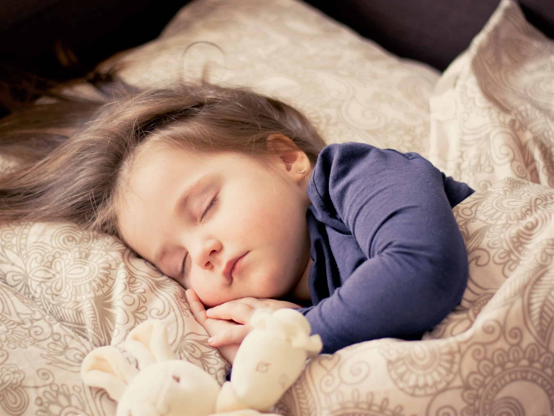 good sleep shown by a baby on bed