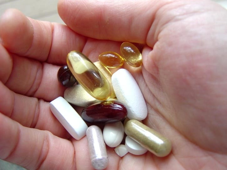 hand, full, pills - Should We Take Supplements